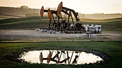 Pumpjacks draw out oil and gas from well heads as wildfire smoke hangs in the air near Calgary, Alberta, May 12, 2024.