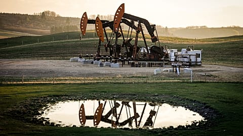 Pumpjacks draw out oil and gas from well heads as wildfire smoke hangs in the air near Calgary, Alberta, May 12, 2024.