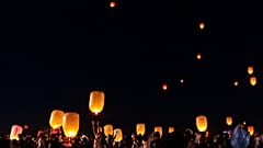 People releasing sky lanterns near ancient pagodas during Thadingyut festival in Bagan