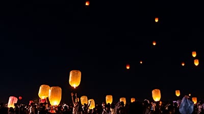 People releasing sky lanterns near ancient pagodas during Thadingyut festival in Bagan