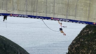 Thomas van Tonder traverse à la force des bras le pont de Bloukrans en enchaînant 600 barres de singe.