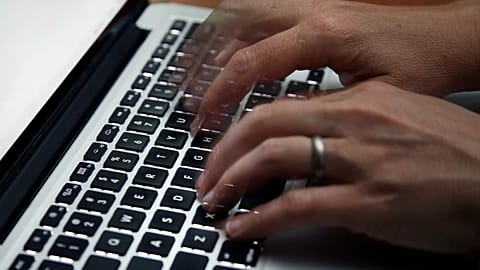 This June 19, 2017 file photo shows a person working on a laptop.