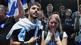Una pareja permanece atenta a los sondeos a pie de urna tras las elecciones en Israel, el 27 de octubre de 2026.