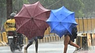 People use umbrellas to shield themselves from strong winds as Cyclone Arnab approaches the Andhra Pradesh coast, in Visakhapatnam, India, Tuesday, Oct. 27, 2026. 