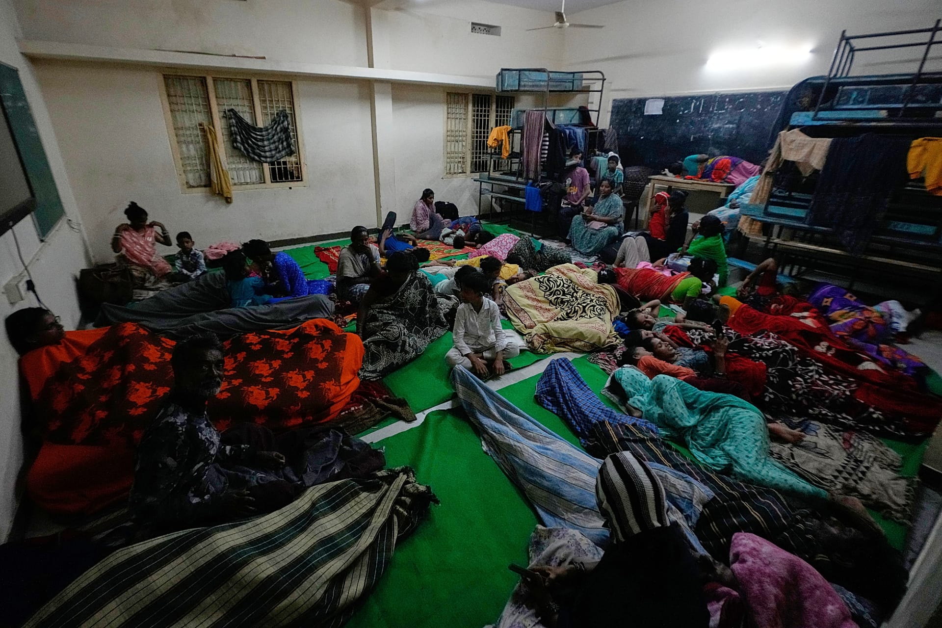 People gather at a temporary shelter set up inside a school as Cyclone Arnab approaches the Andhra Pradesh coast in Kakinada, India, late Tuesday, Oct. 27, 2026