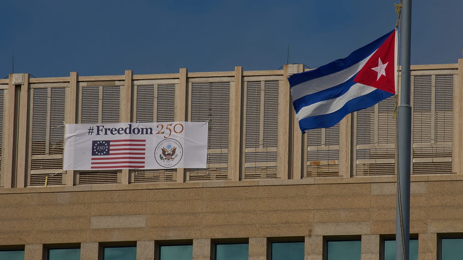 A sign reading "Freedom 250," marking the 250th anniversary of US independence, hangs alongside a Cuban flag in Havana. 28 October 2026.