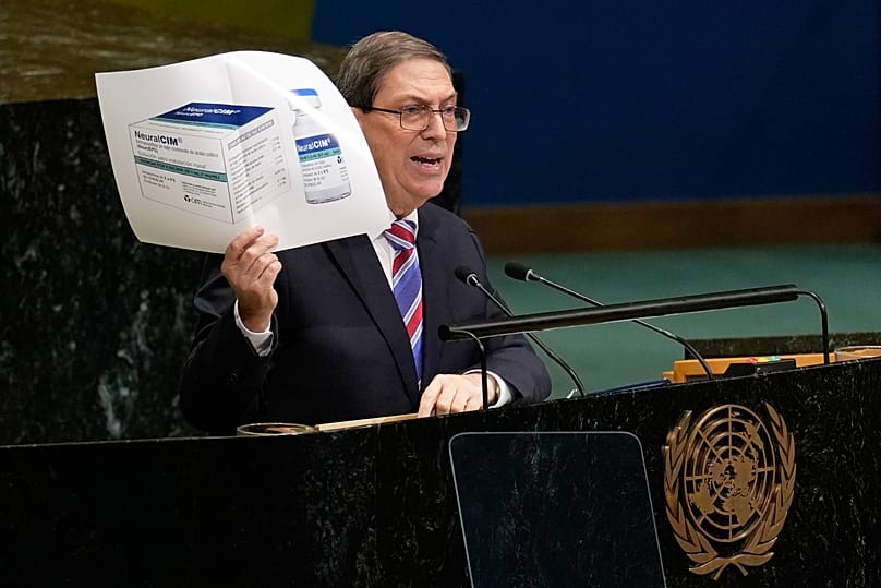 Cuban foreign minister Bruno Rodriguez Parrilla holds up a photo of a medication while speaking at United Nations headquarters. 28 October 2026. 