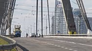Police officers inspect the site of a Russian drone strike on the Northern Bridge across the Dnipro River in Kyiv, Ukraine, Sunday, 4 Oct., 2026.