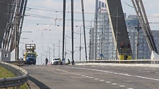 Police officers inspect the site of a Russian drone strike on the Northern Bridge across the Dnipro River in Kyiv, Ukraine, Sunday, 4 Oct., 2026.