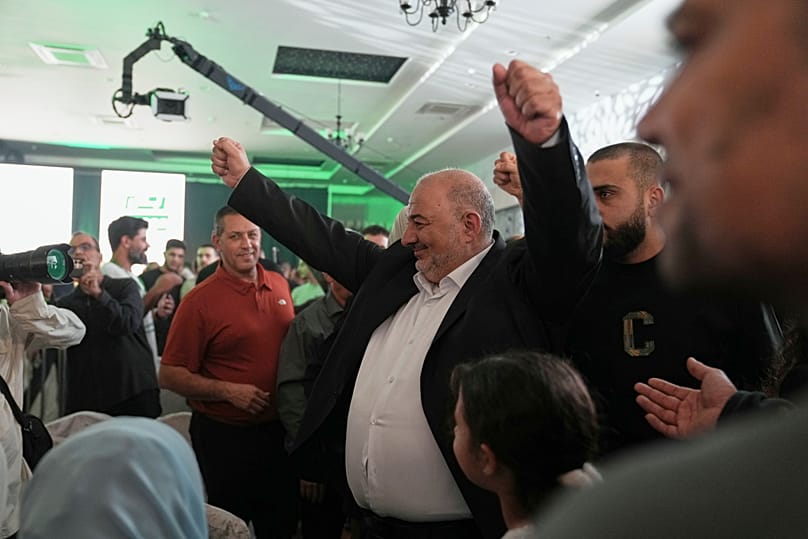 Israeli lawmaker Mansour Abbas, leader of the Ra'am party, raises his fists as he greets supporters after the release of the first exit poll. 27 October 2026