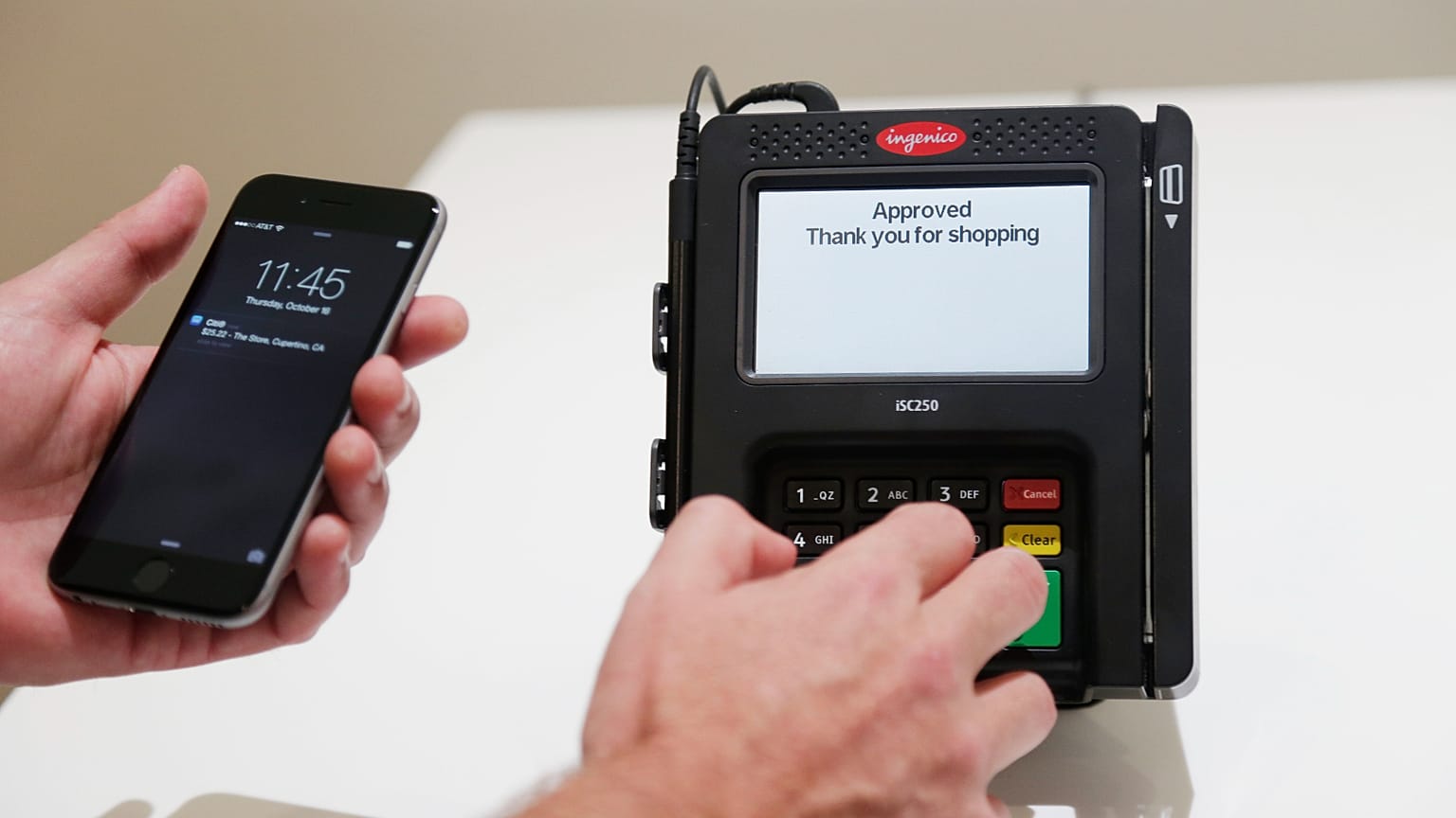 A customer makes a contactless payment using a smartphone at a point-of-sale terminal