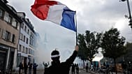 A protester holds a French flag during a demonstration against rising living costs in Strasbourg, France, 24 October 2026.