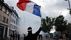 A protester holds a French flag during a demonstration against rising living costs in Strasbourg, France, 24 October 2026.